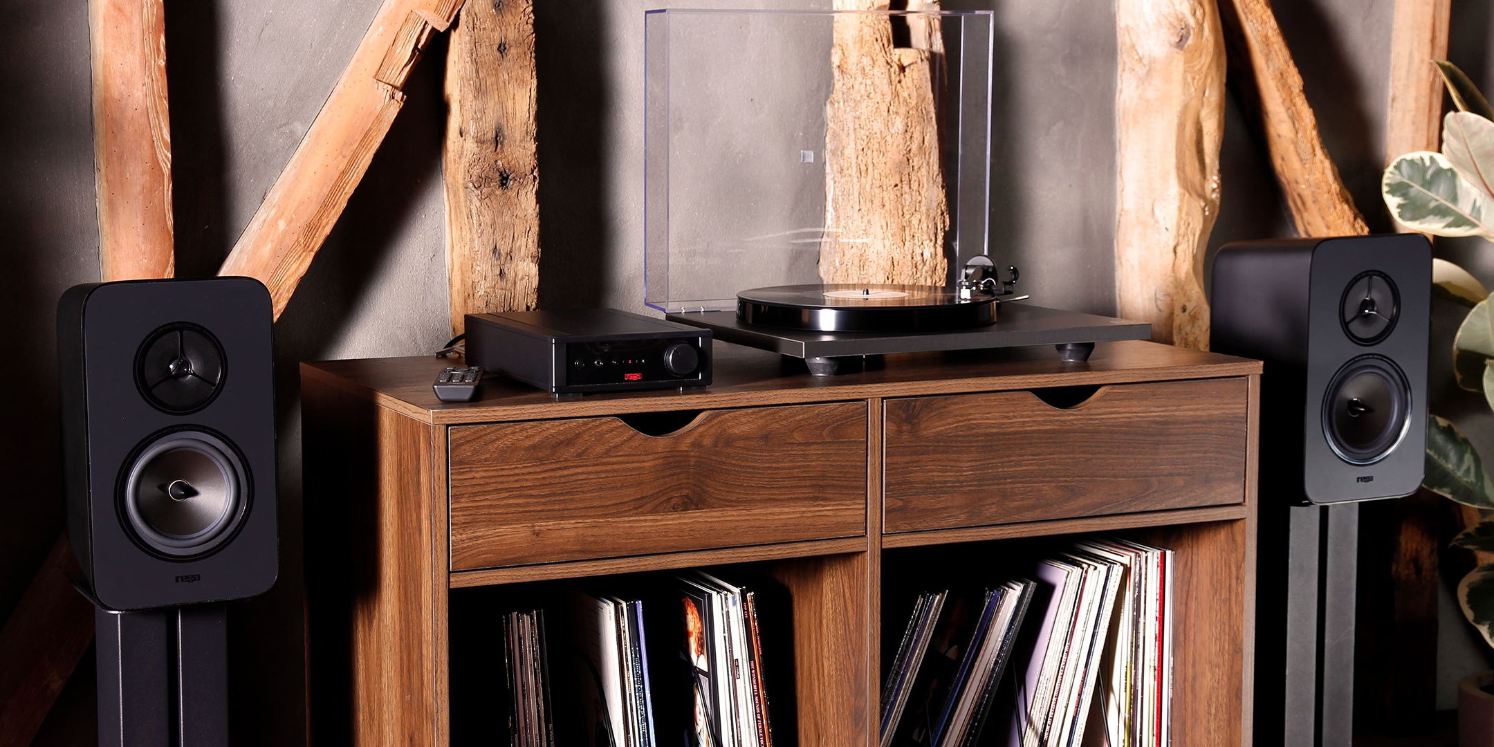 Pic showing a Rega System One audio system on a stylish wood sideboard. Speakers mounted on stands