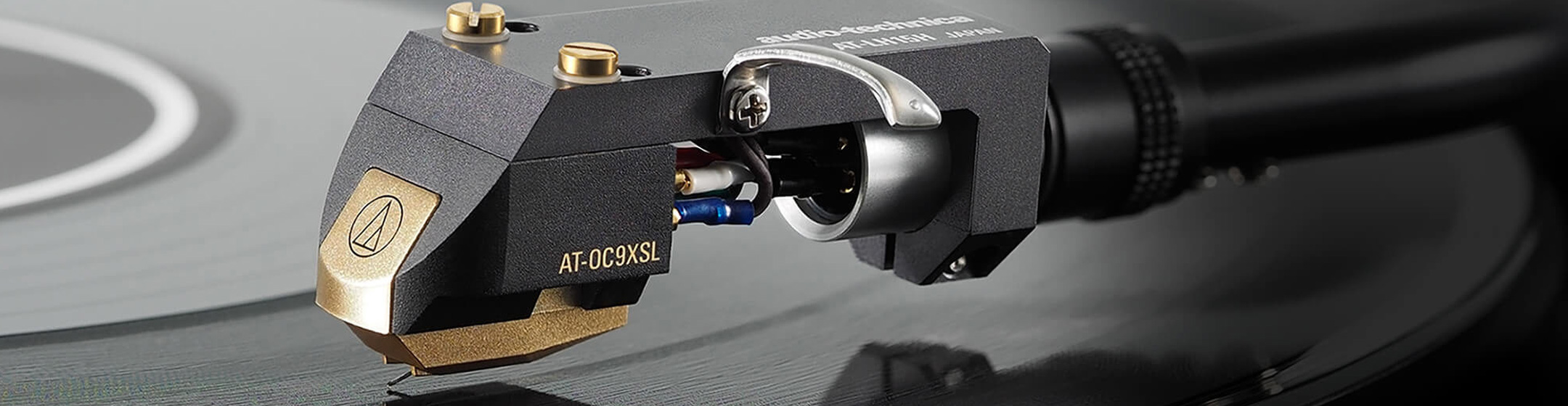 Pic showing an Audio-Technica cartridge on a tone arm playing a vinyl records