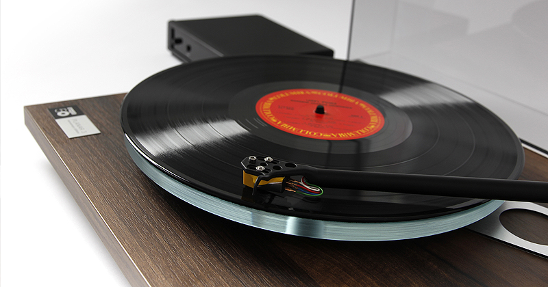 Pic showing a Rega Planar 3 turntable lid open with a record playing on the platter